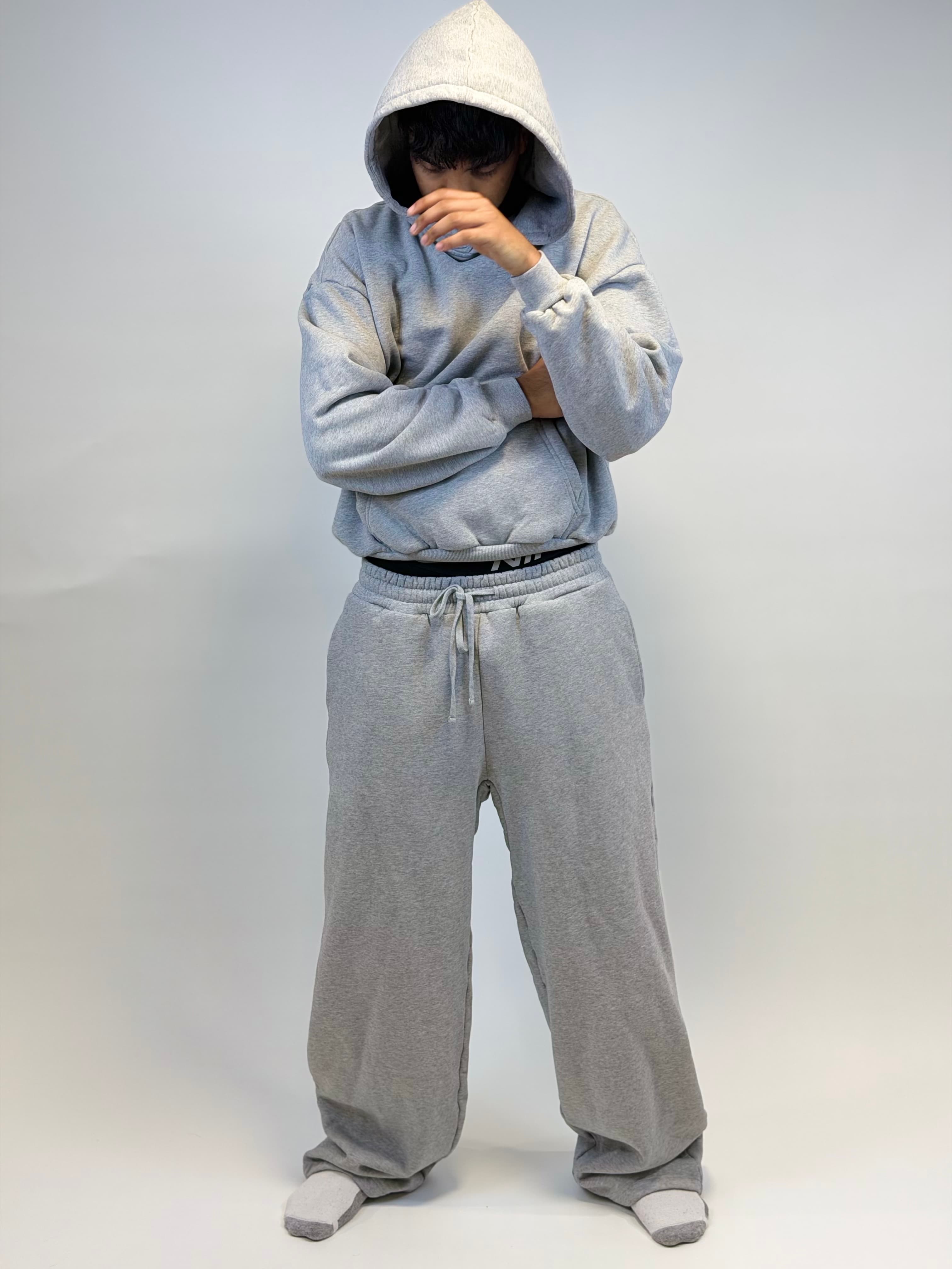Model wearing a grey VadaWear hoodie and sweatpants set